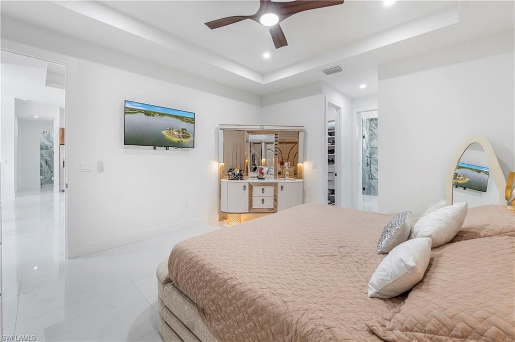 Spacious room featuring white tile flooring, recessed lighting, and a ceiling fan