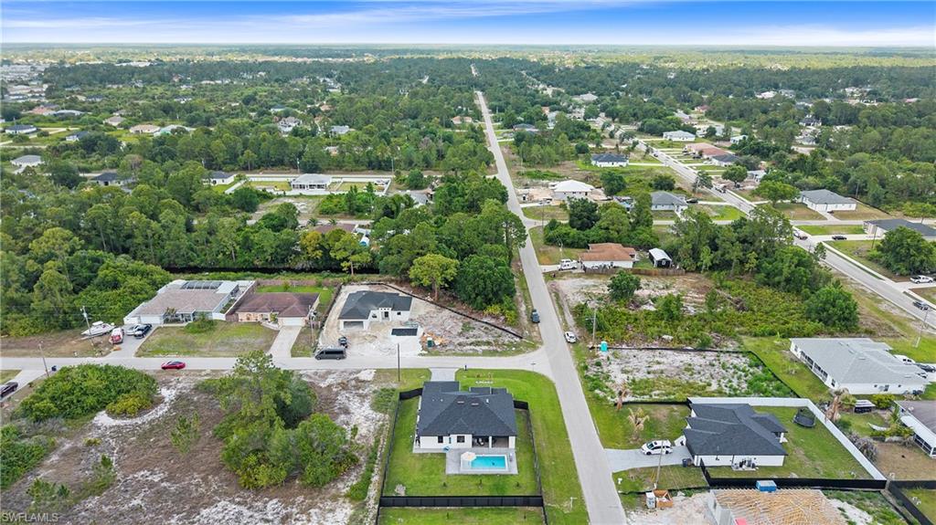 Aerial perspective showcasing a residential neighborhood with a mix of developed and undeveloped lots