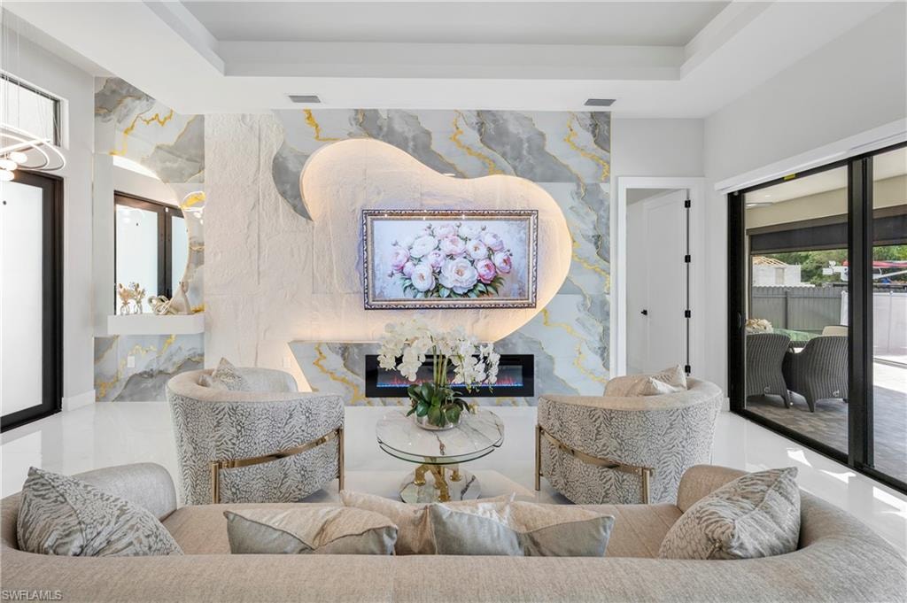 Statement wall featuring marble-finish paneling and an integrated fireplace