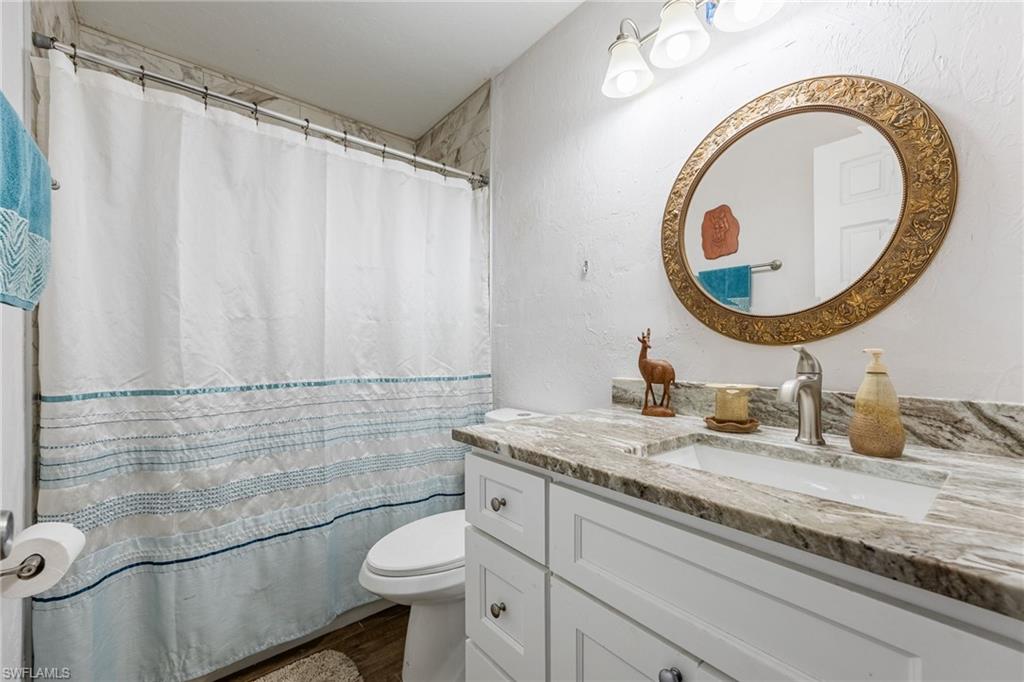 Guest bath with granite, white shaker vanity