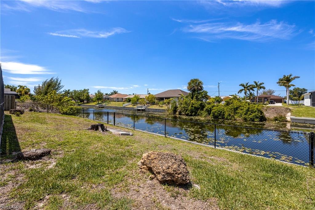 Fenced in back yard with 6 foot privacy in the front and sides of the home with black chain link along the sea wall