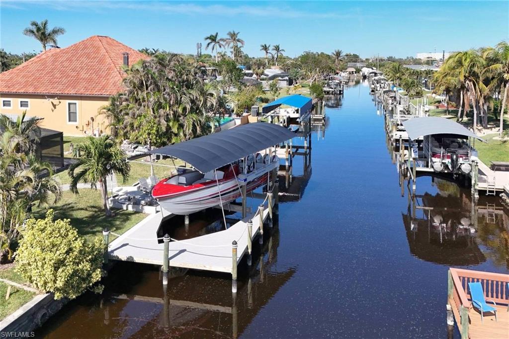 Dock area featuring boat lift and a water view