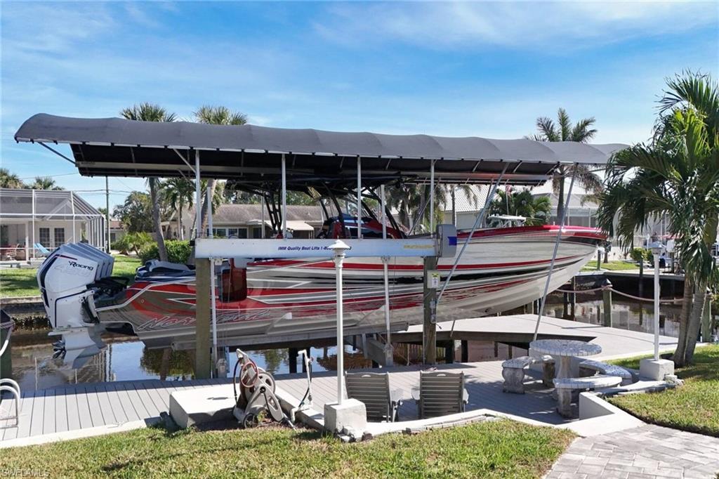 Dock area featuring boat lift and a water view