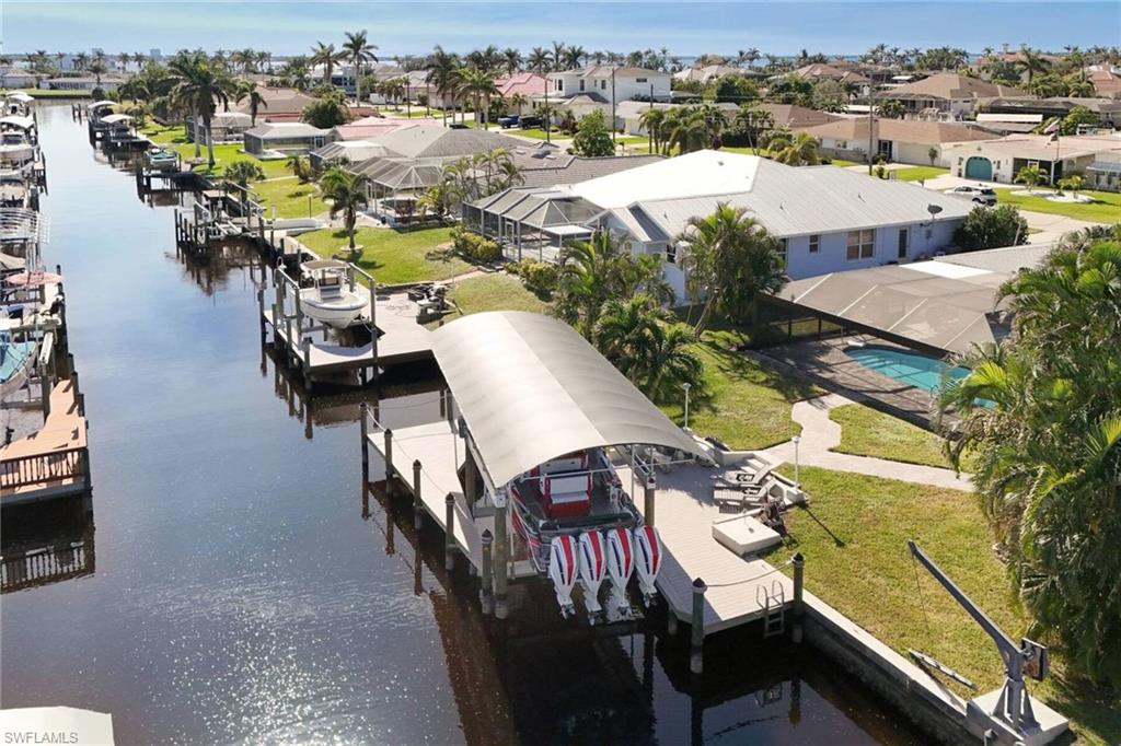 Aerial view of residential area featuring a nearby body of water