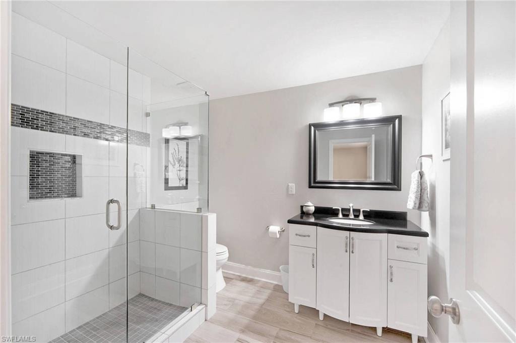 Bathroom with vanity and a shower stall
