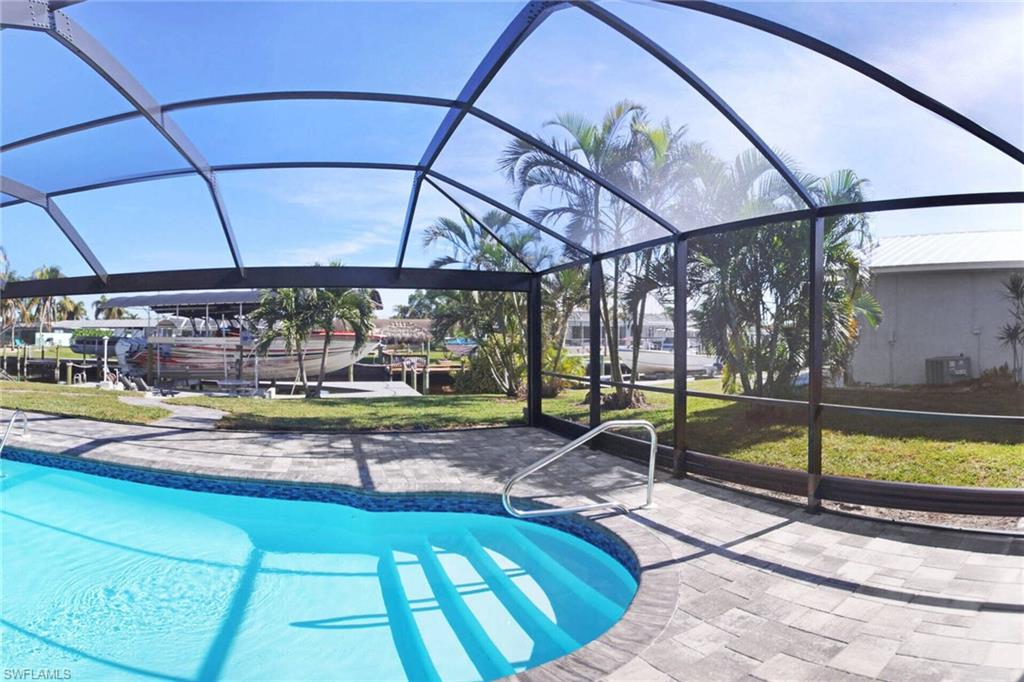 Swimming pool featuring glass enclosure and a sunroom