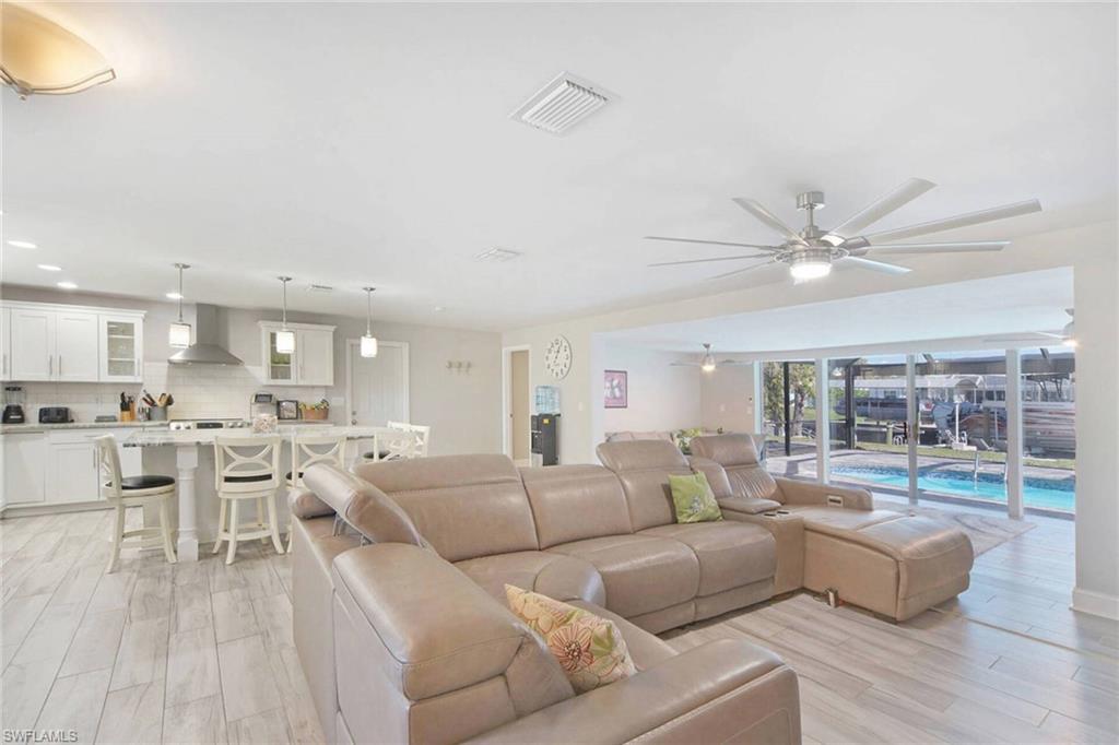 Living room featuring a ceiling fan, wood finish floors, and recessed lighting