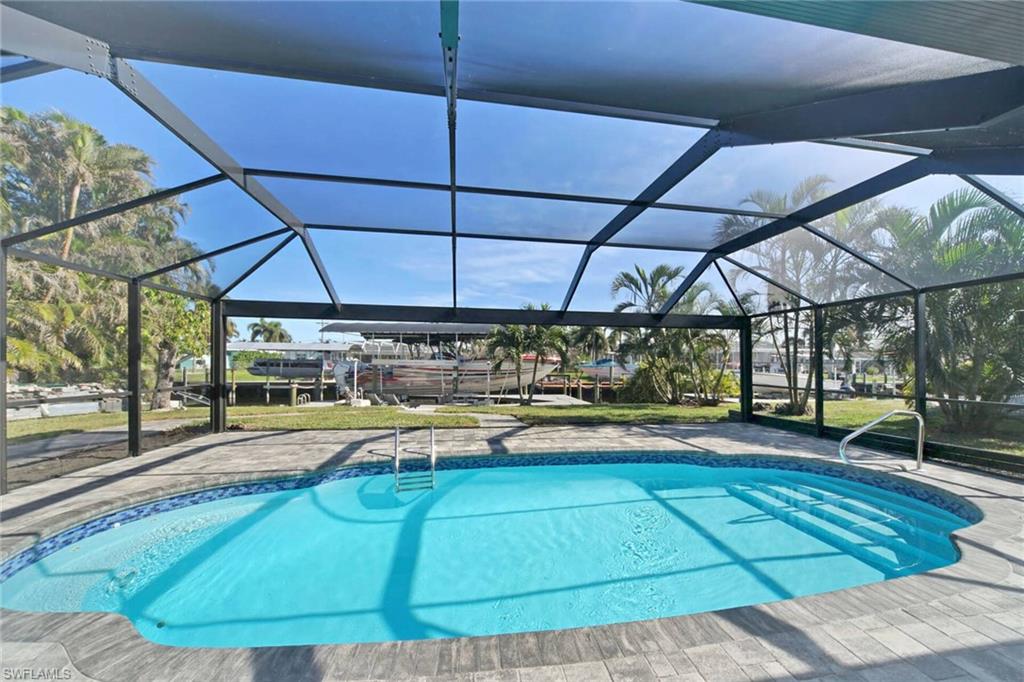 Outdoor pool with a lanai and a sunroom
