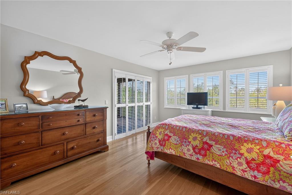 Primary Bedroom featuring access to exterior, light wood-style flooring, and ceiling fan