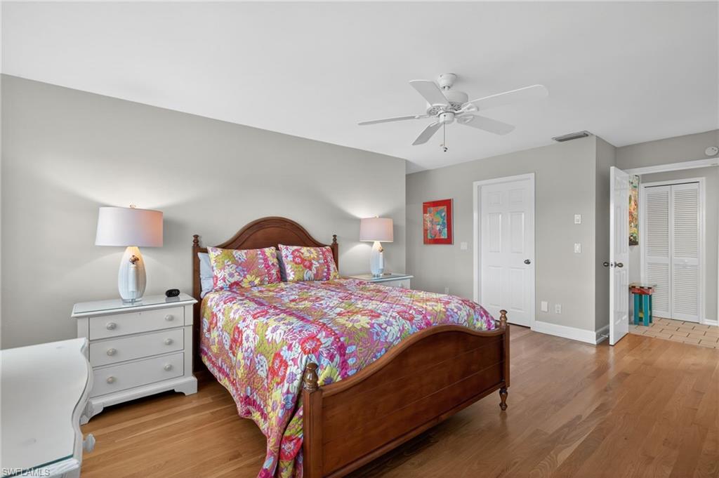 Primary Bedroom featuring light wood-style floors, ceiling fan, and a closet