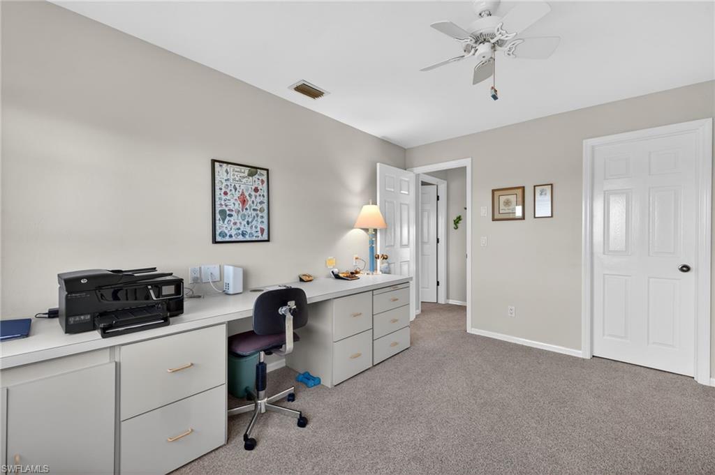 Bedroom/Office space featuring a ceiling fan and light colored carpet