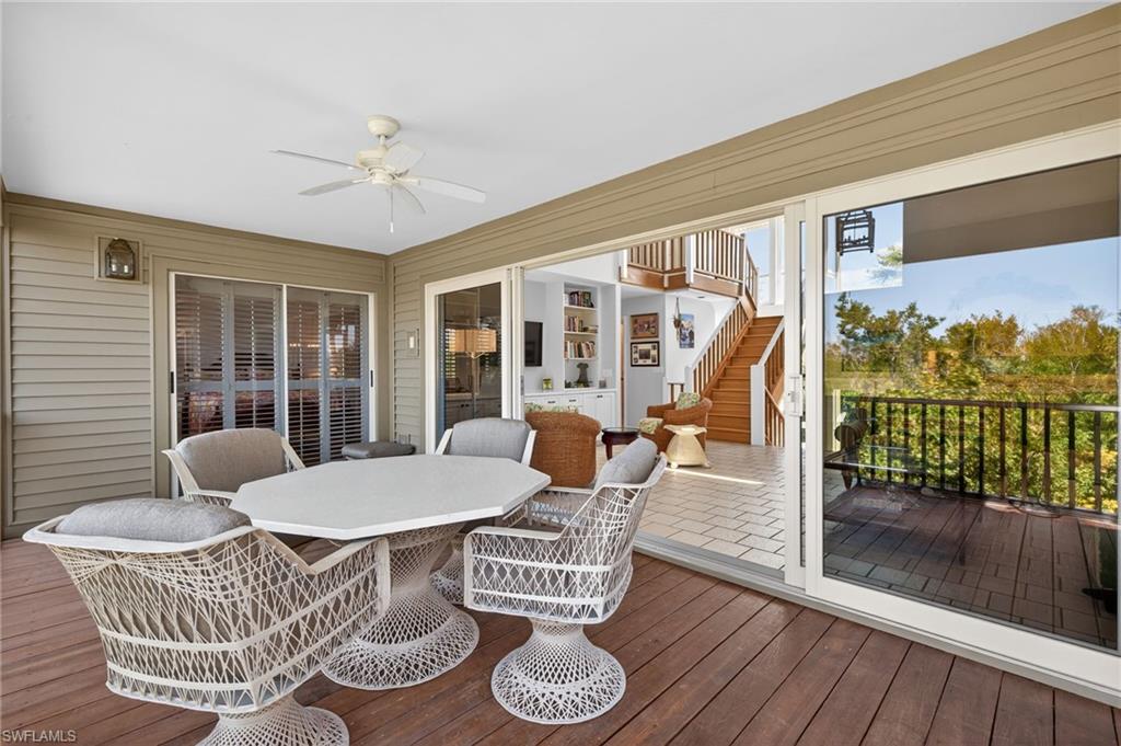 Sunroom featuring outdoor dining area and a ceiling fan