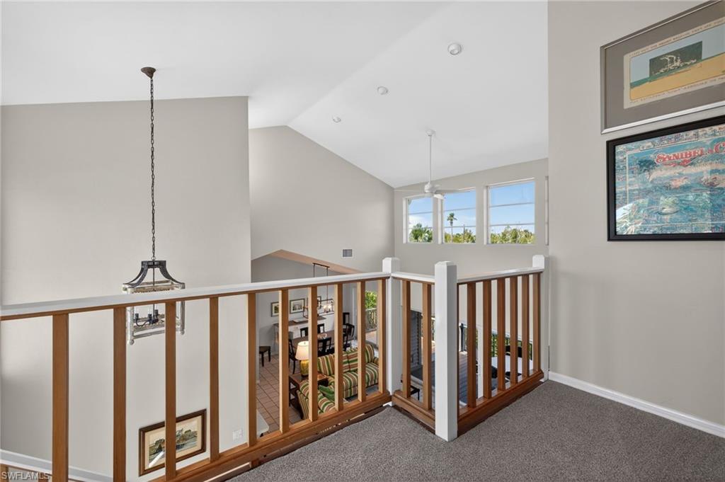 Hall featuring carpet and vaulted ceiling