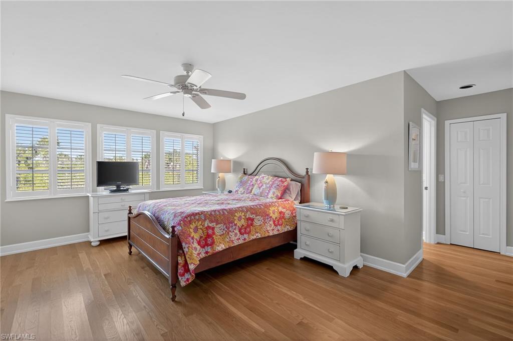 Primary Bedroom with light wood-style floors, ceiling fan, and a closet