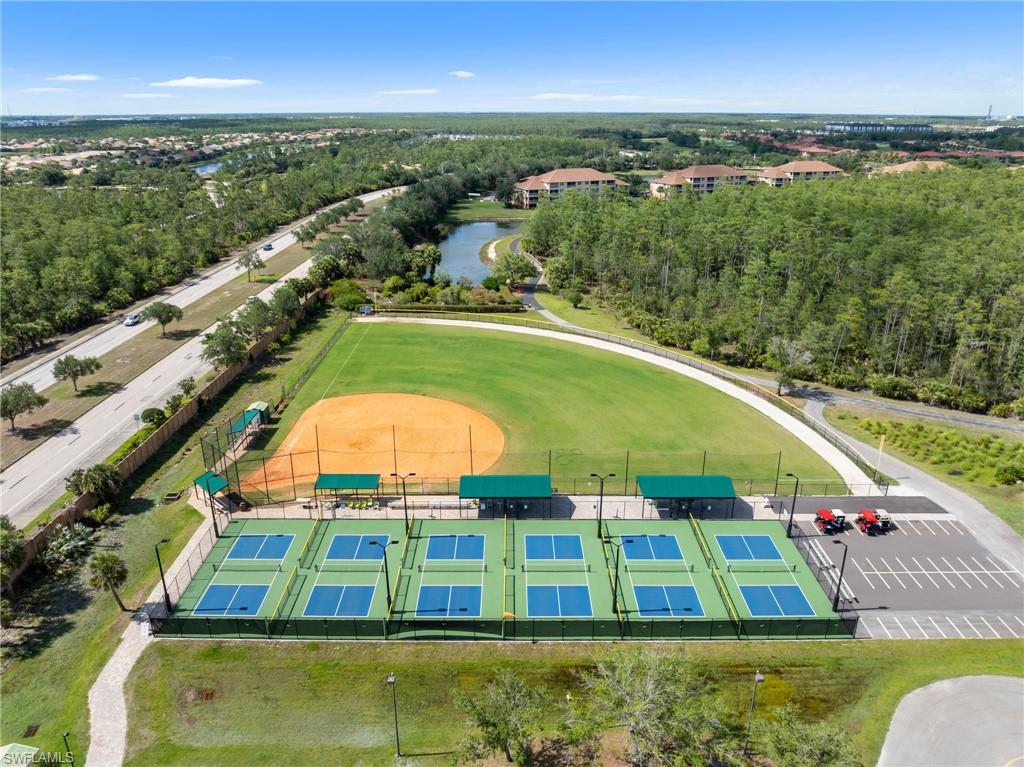 Aerial view showcasing the community amenities, including a baseball field and several pickleball courts