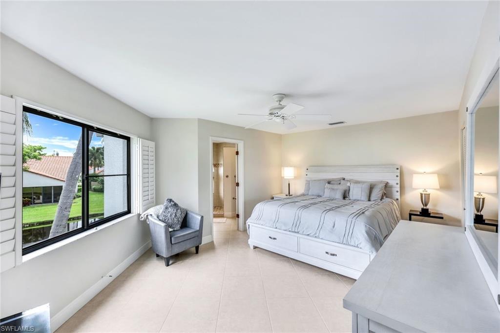 Bedroom featuring light tile patterned flooring and ceiling fan