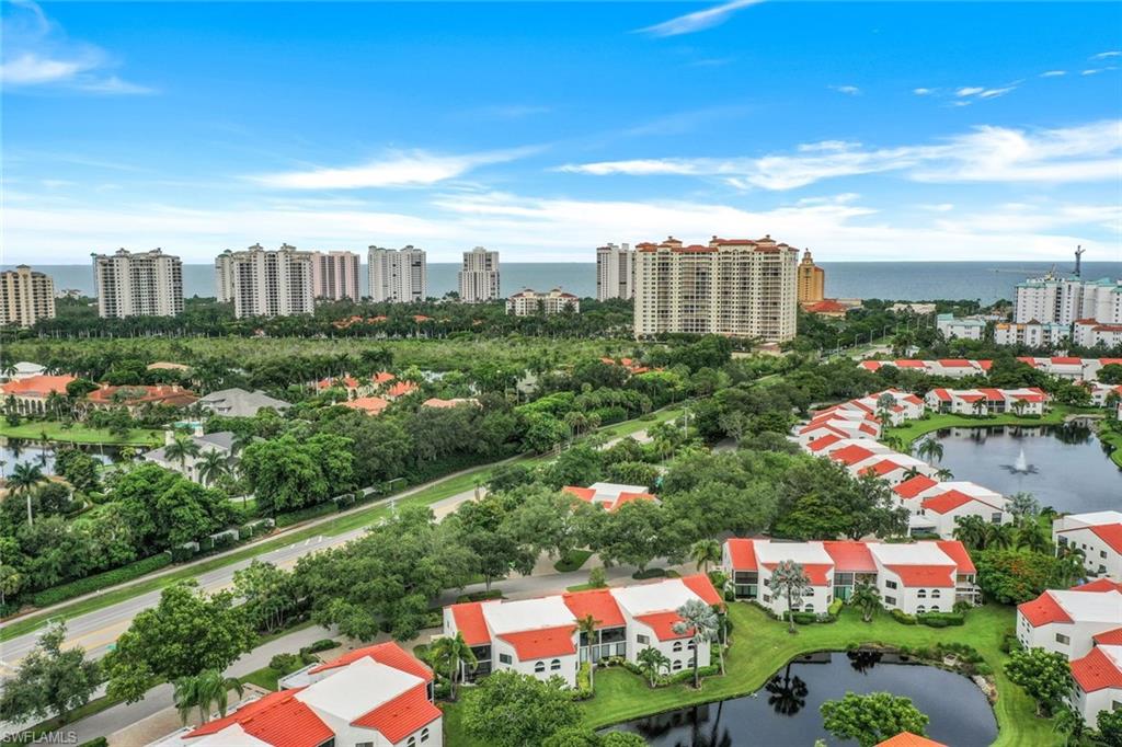 Birds eye view of property with a water view