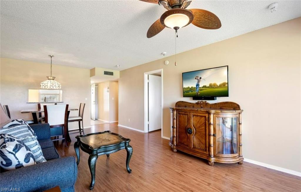 The property features hard surface flooring, a ceiling fan with integrated lighting, and neutral-toned walls