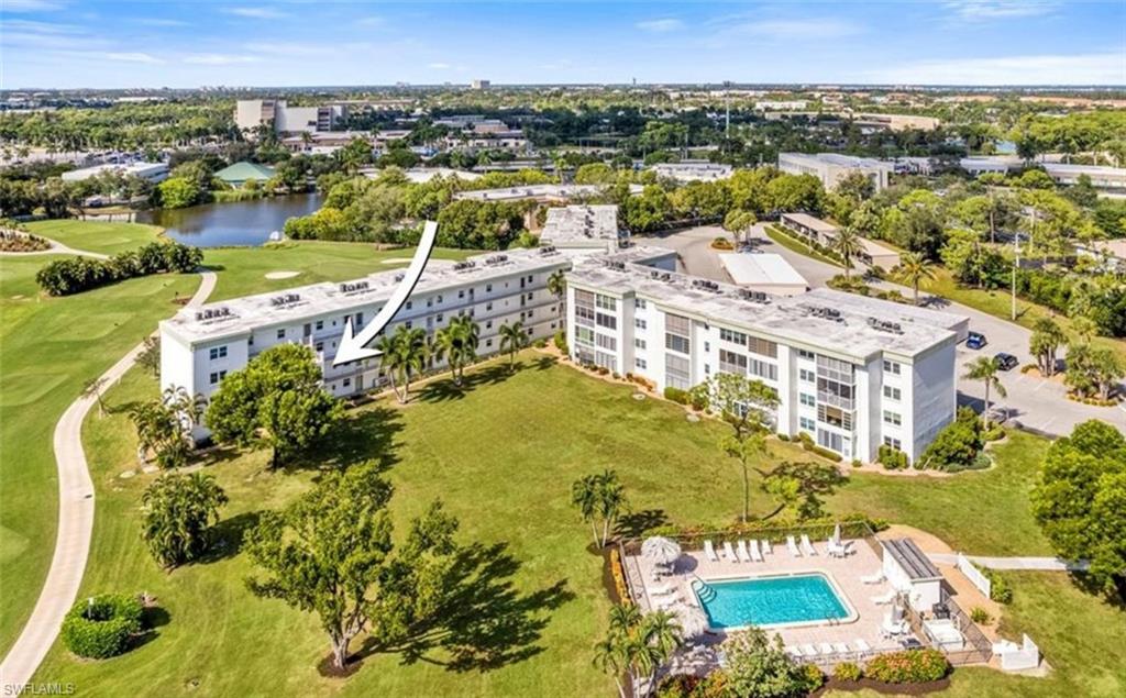 The property offers views of a golf course with sand traps and a winding path, surrounded by mature trees and lush green lawns