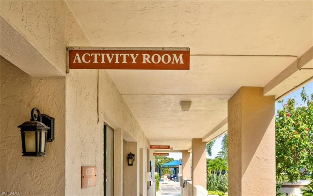 An Activity Room sign indicates a dedicated space for activities, complemented by exterior wall sconces and covered walkways