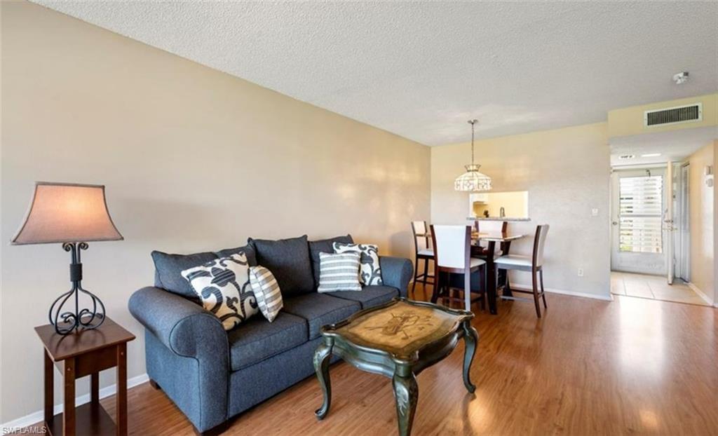 Living area with wood-style flooring and light-colored walls