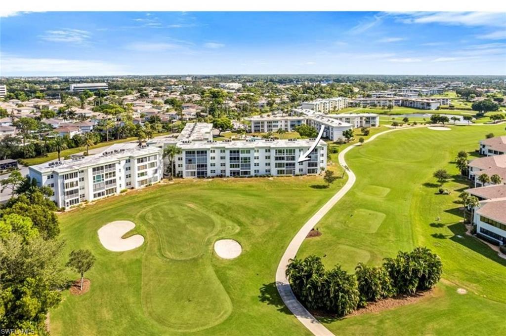 This property offers stunning views of the golf course, featuring expansive green lawns and sand traps