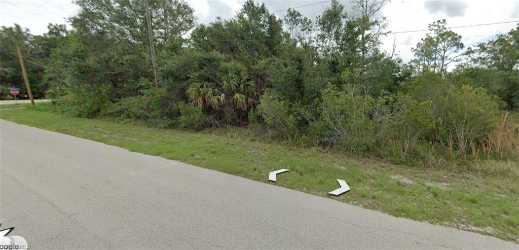 View of asphalt road featuring traffic signs