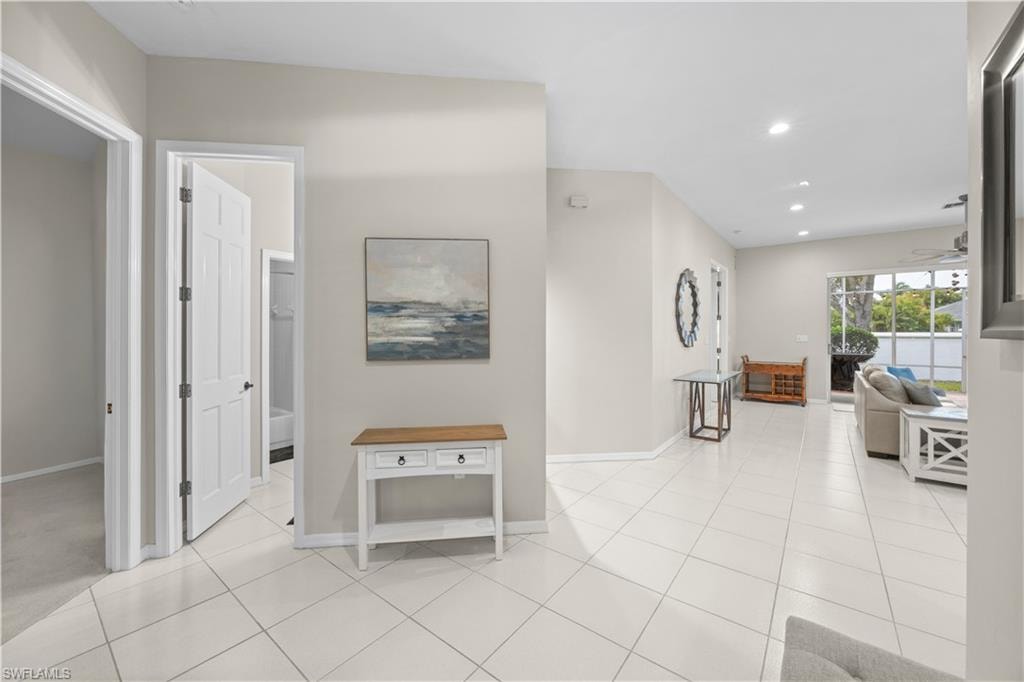 The property features light-colored tile flooring throughout the main areas, providing a bright and cohesive aesthetic