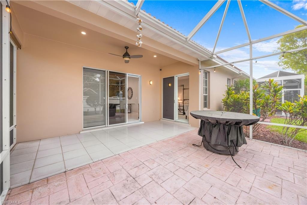 The property features a screened patio area with tile flooring and a ceiling fan, providing an inviting outdoor space