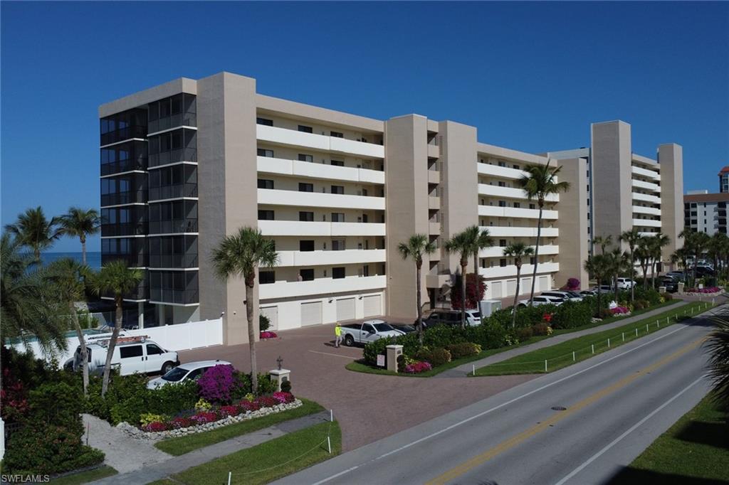Multi-story condominium building featuring a stucco exterior and private balconies