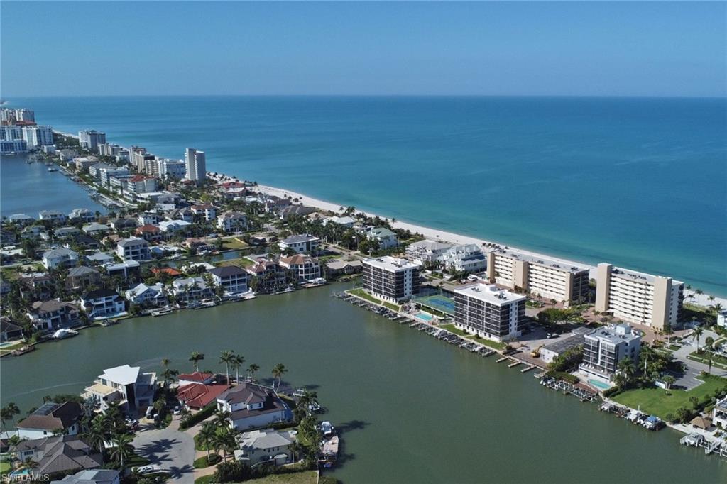 Coastal community featuring waterfront properties, direct beach access, and deep blue ocean