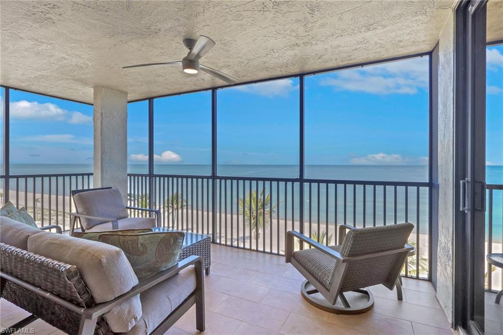 Screened balcony featuring expansive ocean and beach scenery