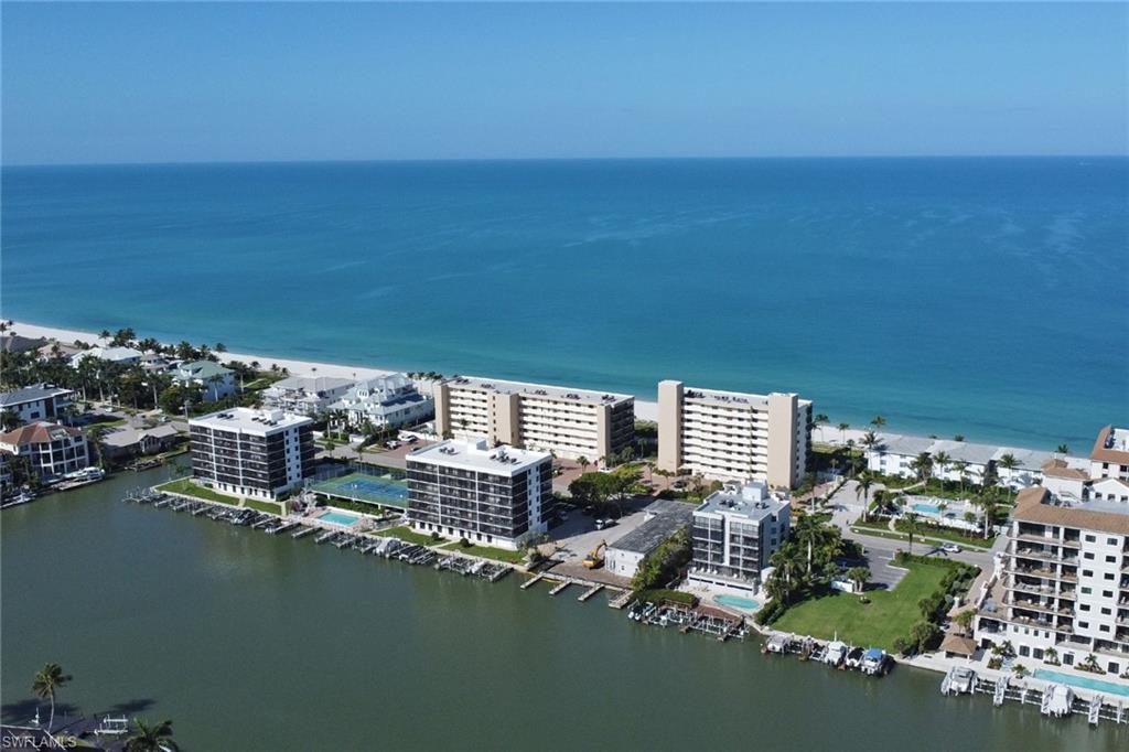 Waterfront condominium buildings featuring private boat docks, onsite tennis courts, and a swimming pool