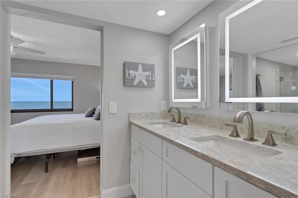Dual vanity featuring light-toned countertops and undermount sinks