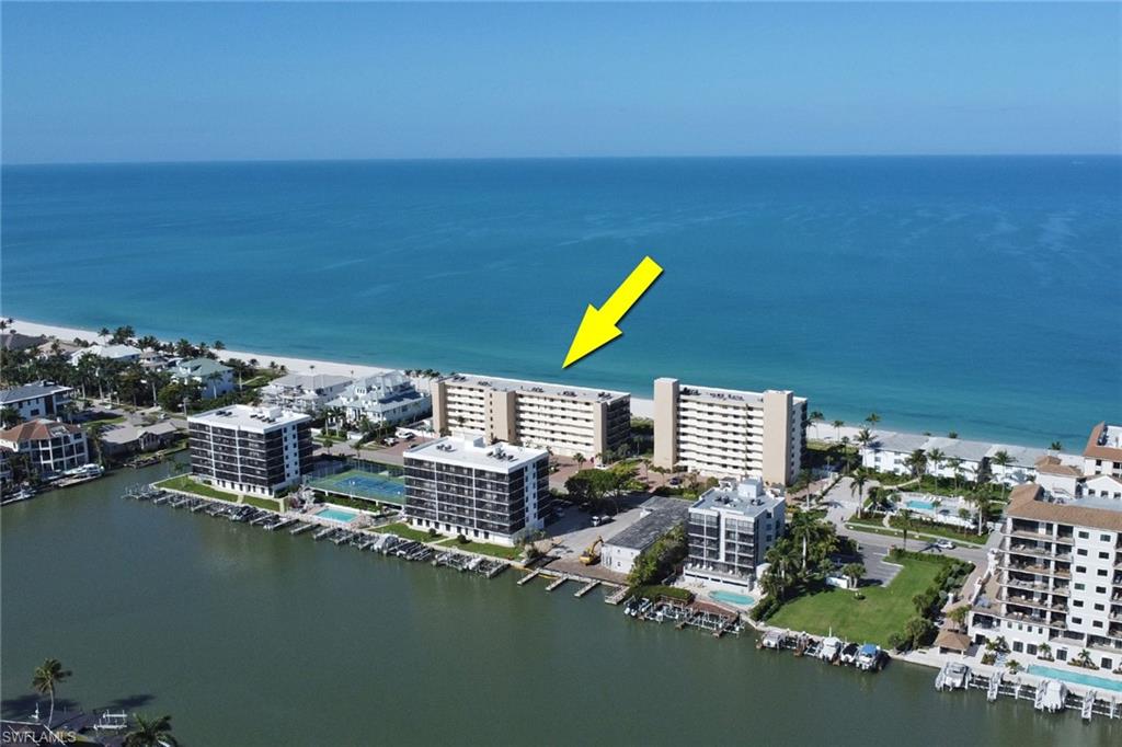 Waterfront condominium complex featuring a beachfront setting, direct Gulf access, boat docks, and on-site tennis courts