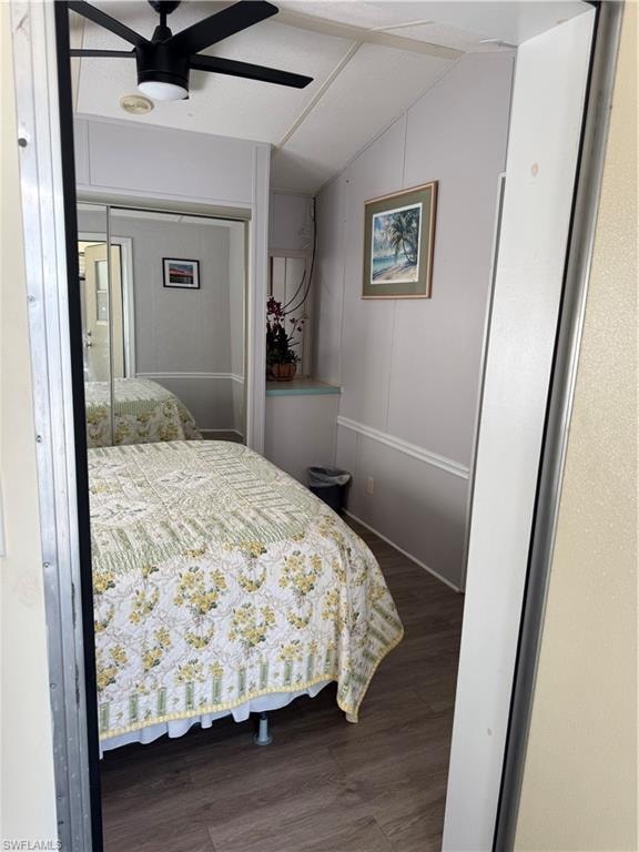 doors, wood-finish flooring, and white paneled walls