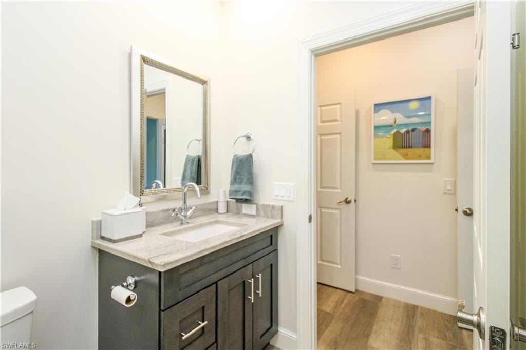 Bathroom with vanity, toilet, and hardwood / wood-style flooring