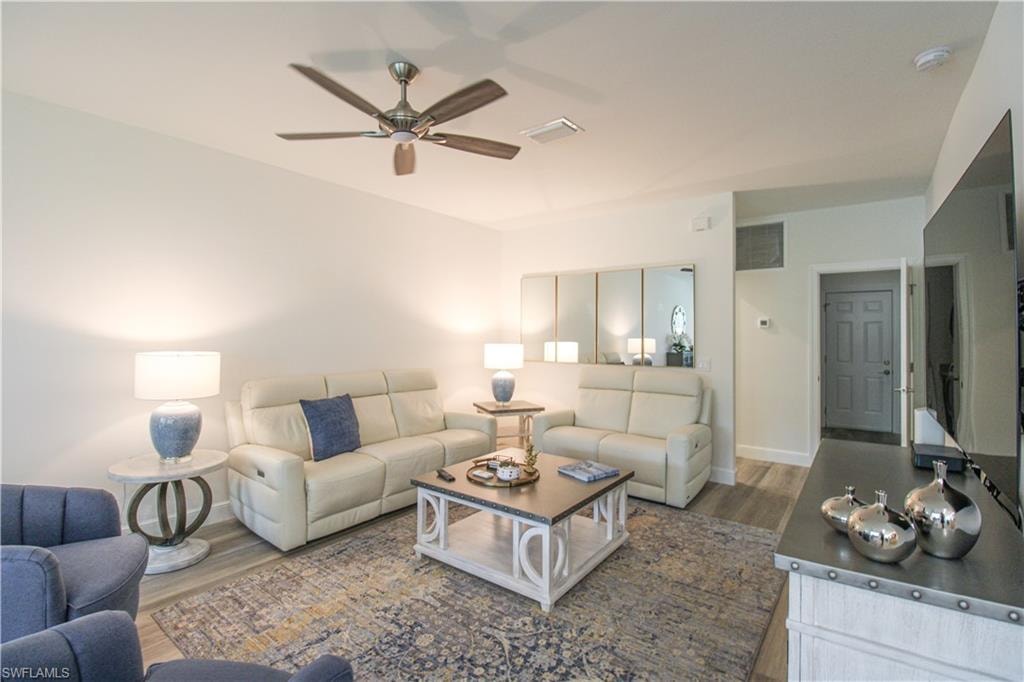 Living room featuring ceiling fan and wood-type flooring