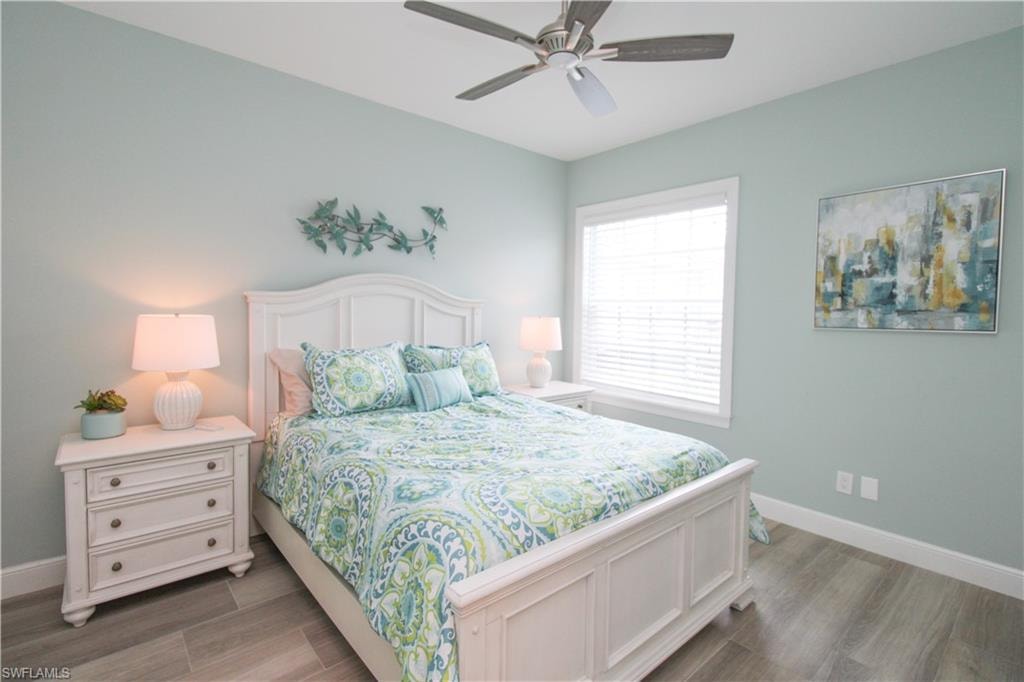 Bedroom with wood-type flooring and ceiling fan
