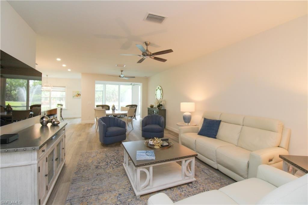 Living room with hardwood / wood-style floors and ceiling fan