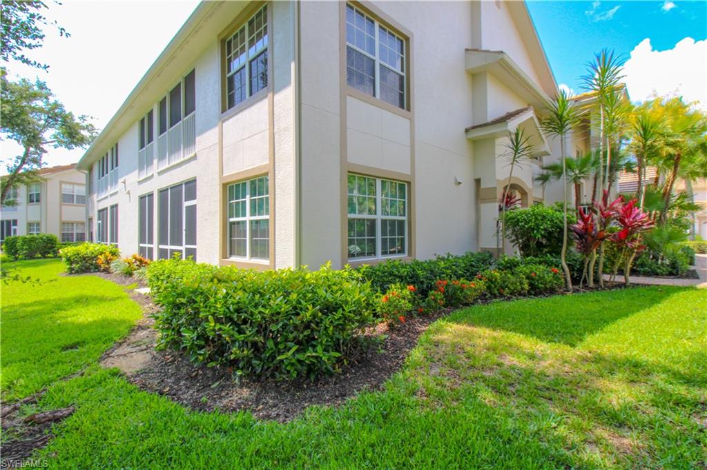 View of side of home with a lawn