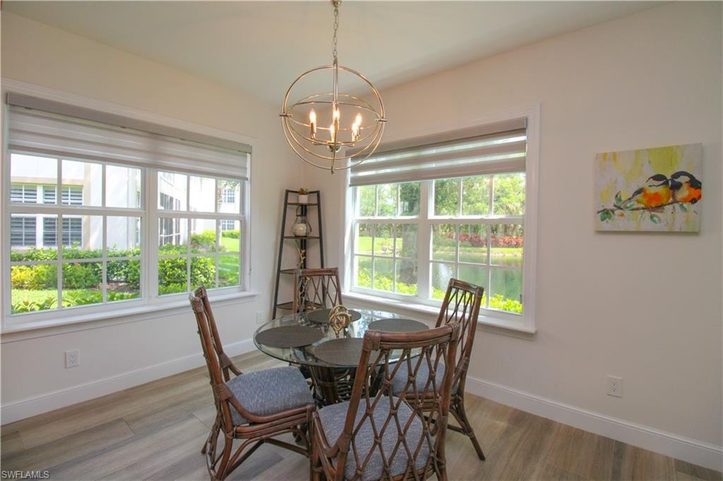 Dining space featuring a notable chandelier and wood-type flooring