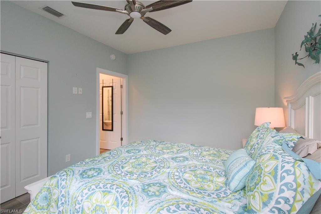 Bedroom with ceiling fan and a closet