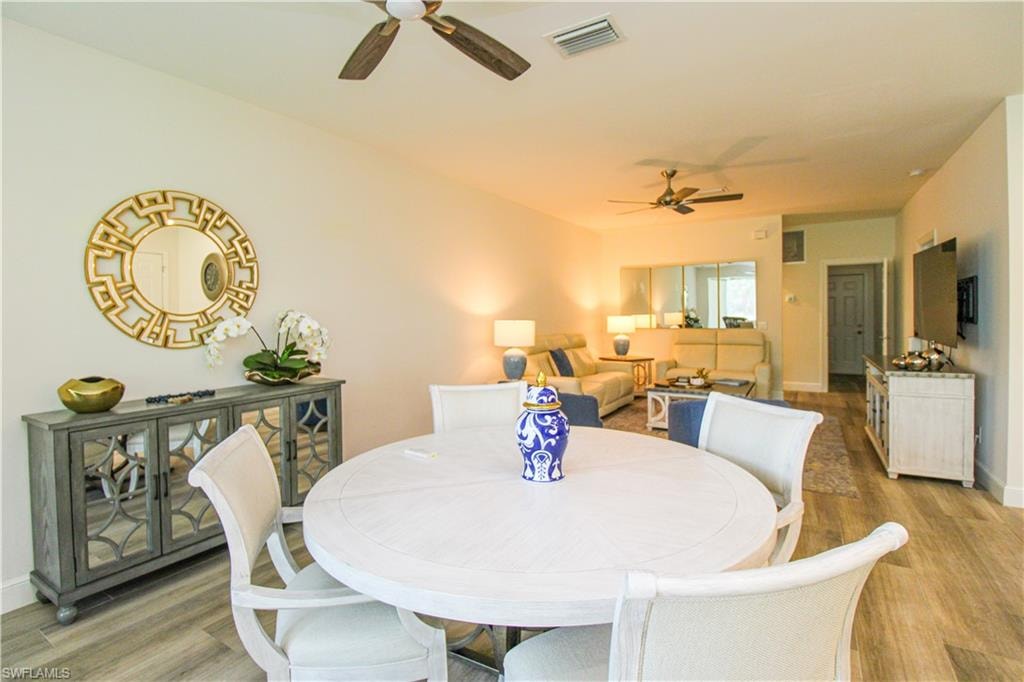 Dining room featuring wood-type flooring and ceiling fan