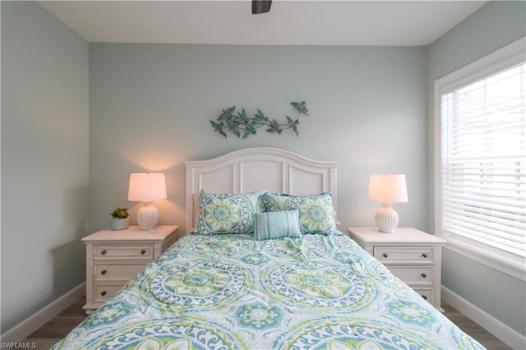 Bedroom with dark wood-type flooring and ceiling fan
