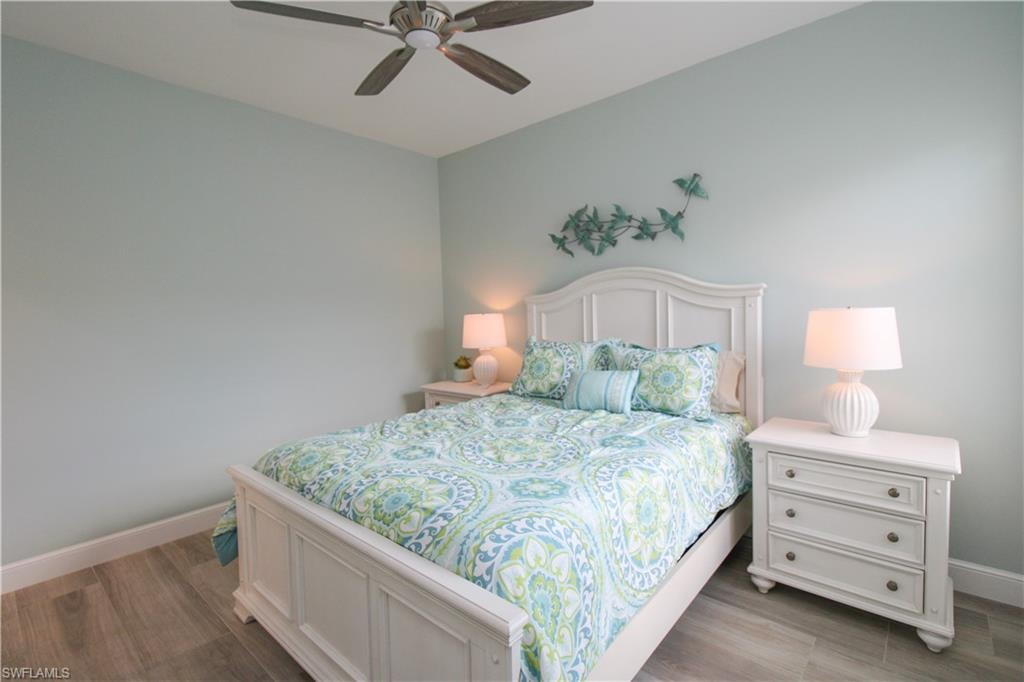 Bedroom with ceiling fan and light hardwood / wood-style floors