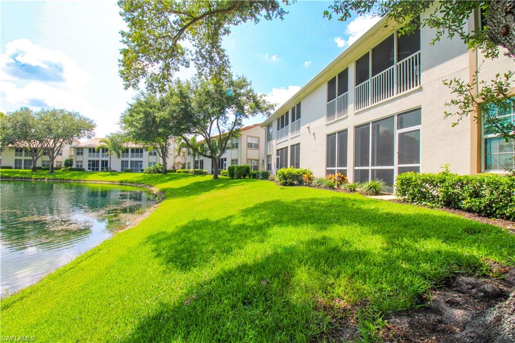 View of home's community featuring a lawn and a water view