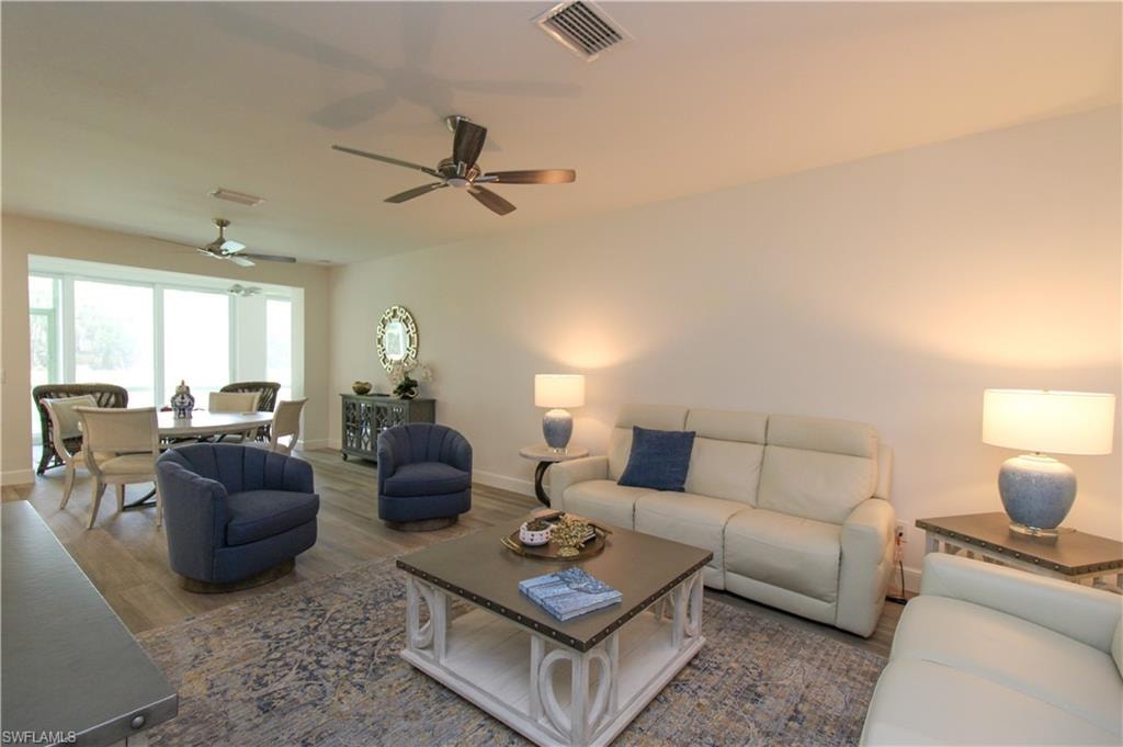 Living room featuring wood-type flooring and ceiling fan