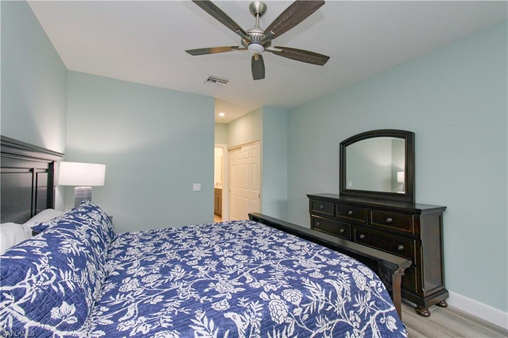 Bedroom featuring a closet, wood-type flooring, and ceiling fan