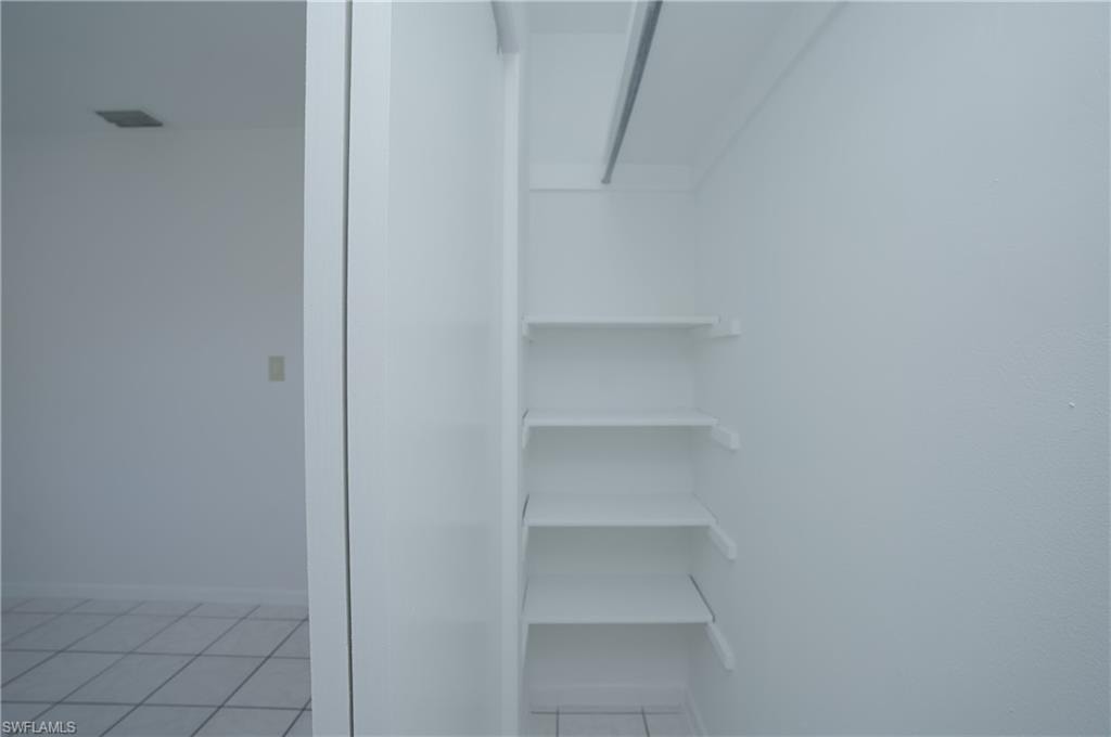 This property features an interior closet with built-in shelving, providing convenient storage